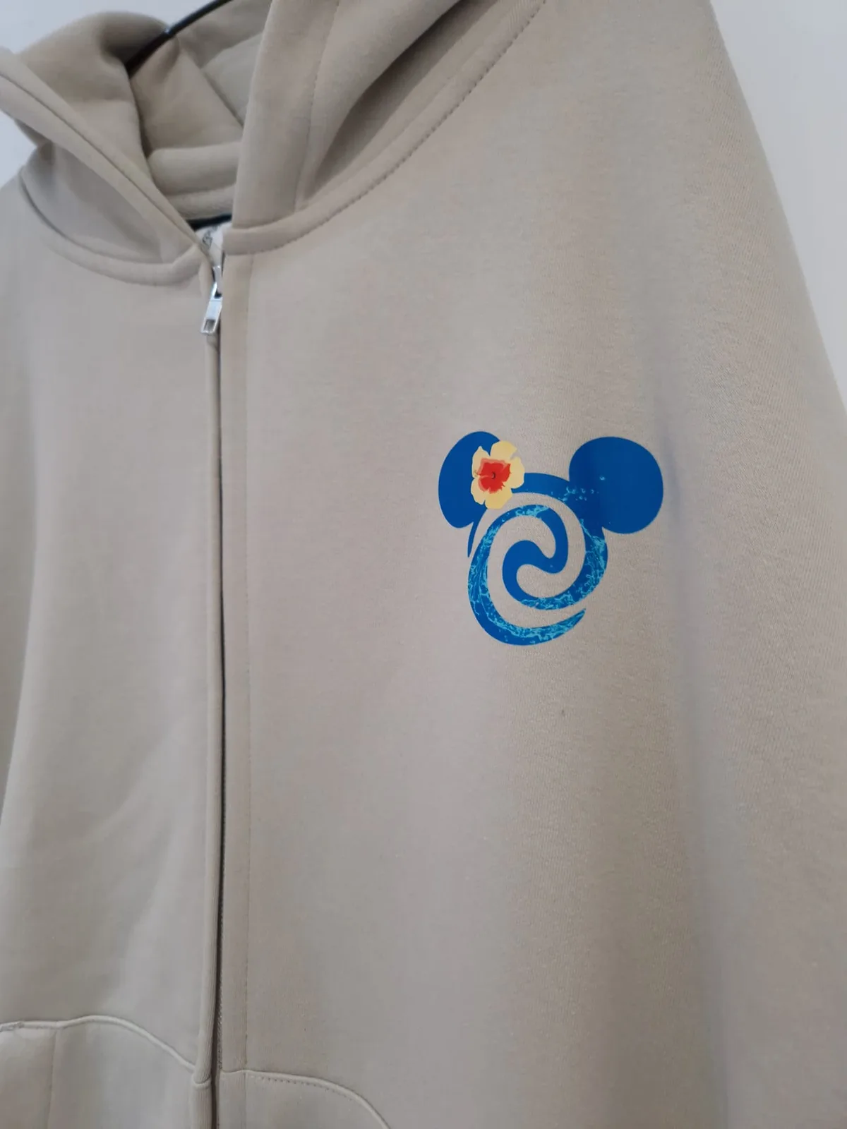 Beige zip hoodie with colourful chest graphic