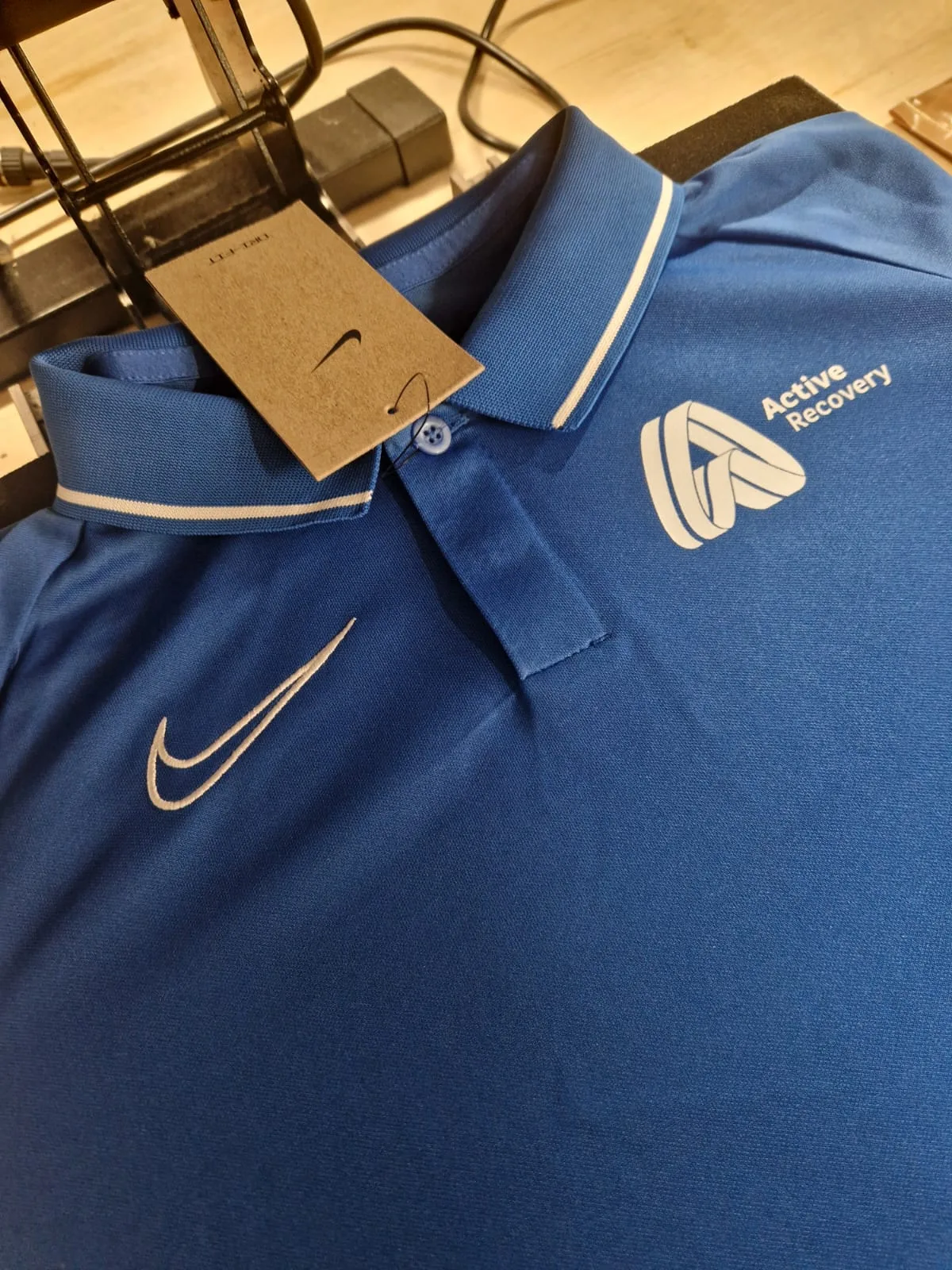 Blue Nike polo shirt with Active Lancashire chest logo
