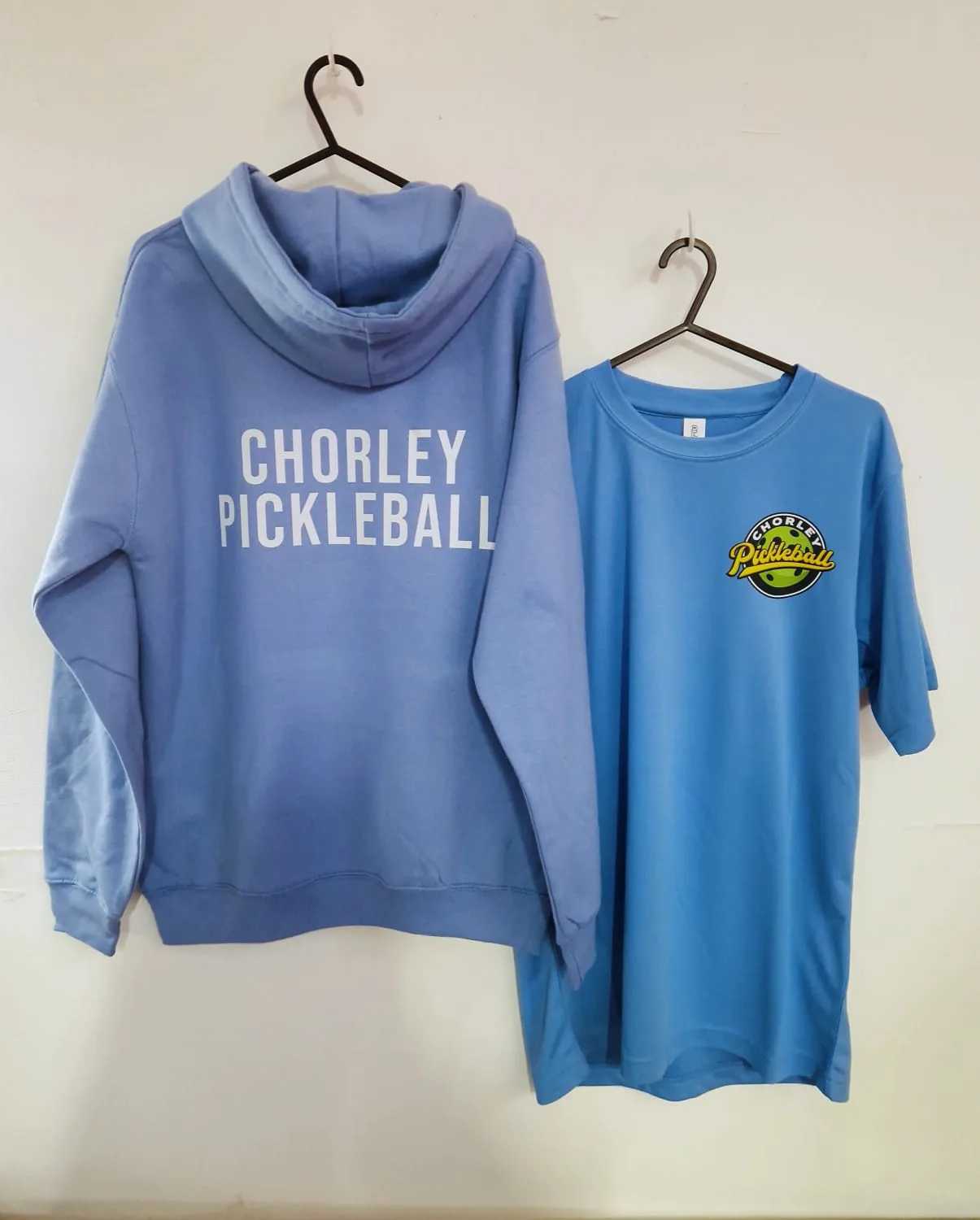 Light blue hoodie with Chorley Pickleball back print alongside matching t-shirt
