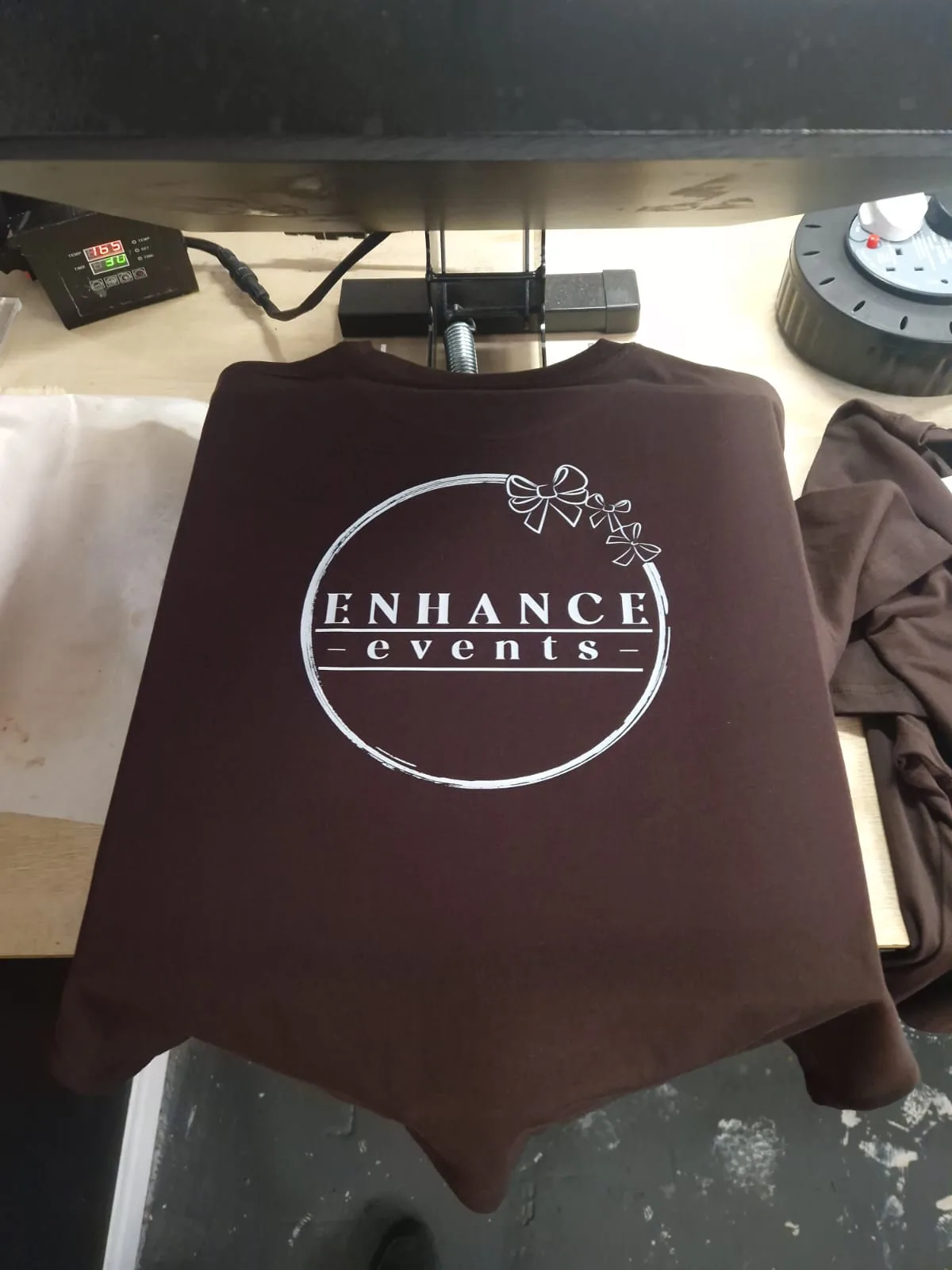 Burgundy t-shirt with Enhance Events chest logo