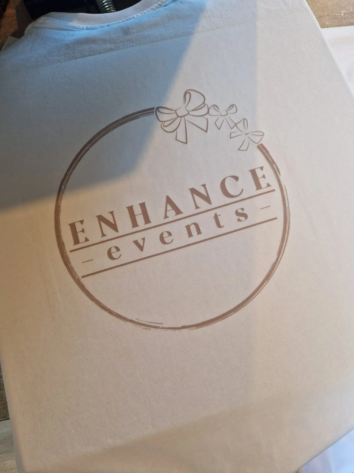 Light-coloured t-shirt with Enhance Events logo