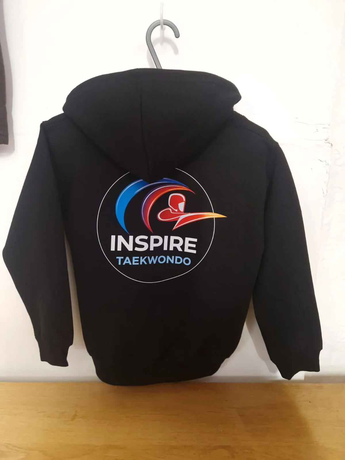 Black hoodie with full-colour Inspire Taekwondo back logo