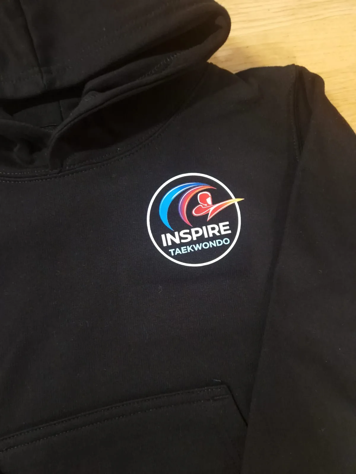 Black hoodie with Inspire Taekwondo chest logo