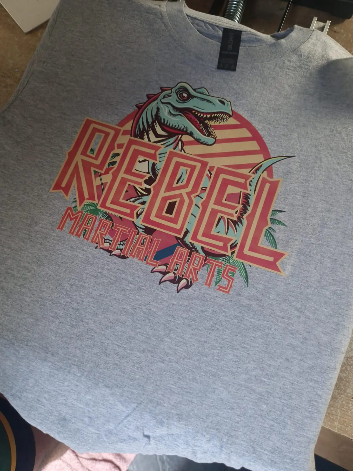 Grey sweatshirt with colourful Rebel Martial Arts graphic